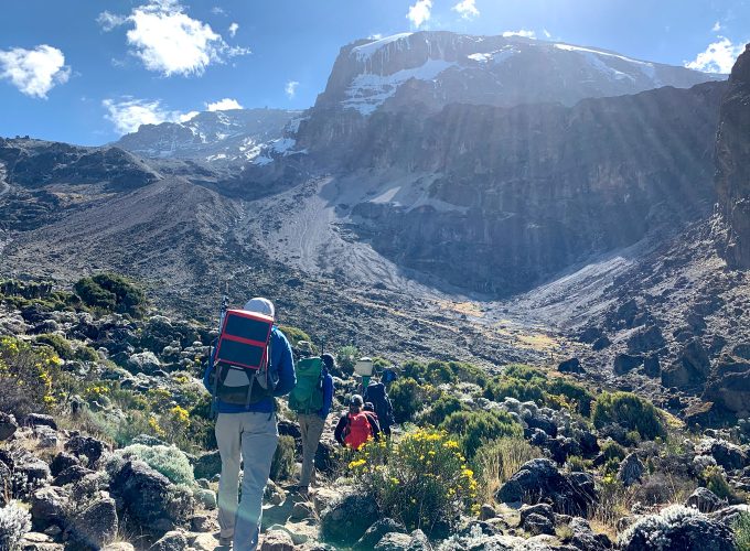 Hikers on the 8 Day Mount Kilimanjaro Lemosho Route with a majestoc view of mount kilimanjaro in view.